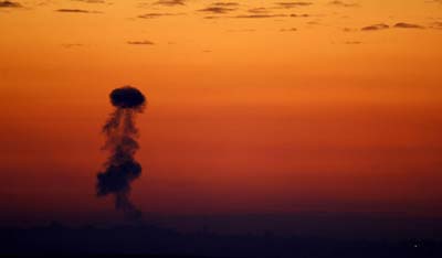 Smoke from Israeli artillery shelling billows from the Gaza Strip during sunset on January 3, 2009. (PATRICK BAZ/AFP/Getty Images)